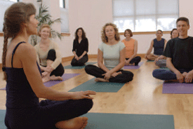 Photo of an instructor teaching a yoga class