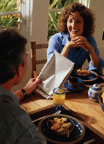 Photo of a man and woman talking over breakfast